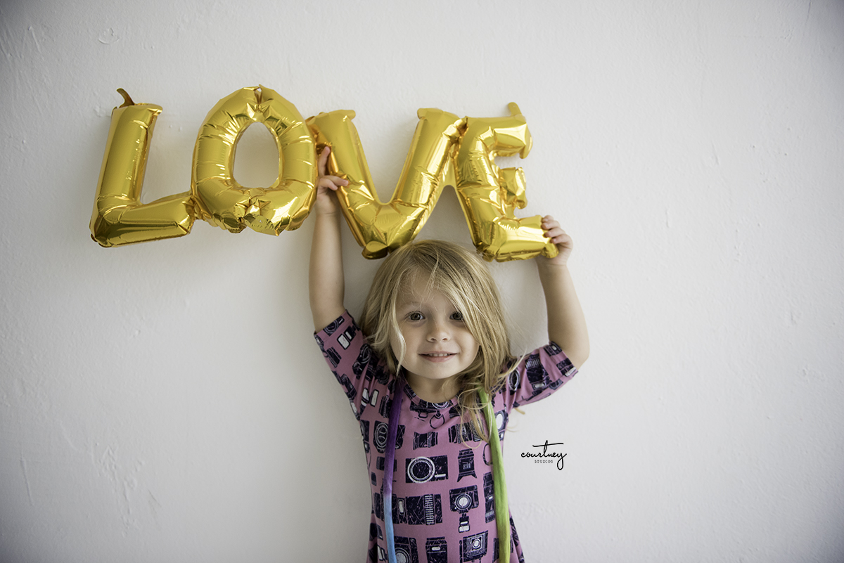 valentines day little girl holding love balloon miami family photographer